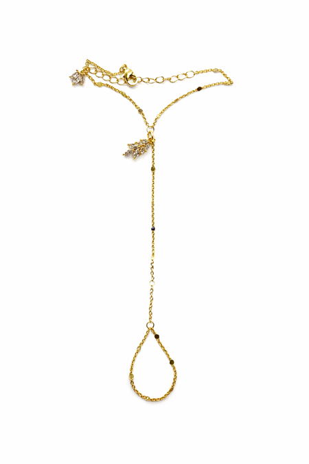 Gold hand chain with a y-style clasp on a white background