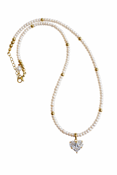 Pearl necklace with a heart-shaped diamond pendant on a white background