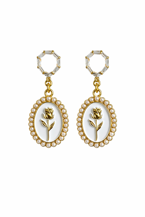 Pair of earrings with floral design and pearl accents on a white background