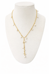 Gold necklace with pearls on a white mannequin bust