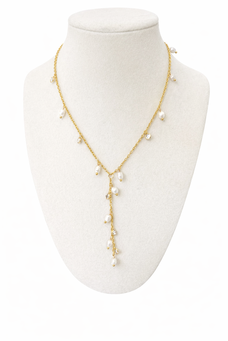 Gold necklace with pearls on a white mannequin bust